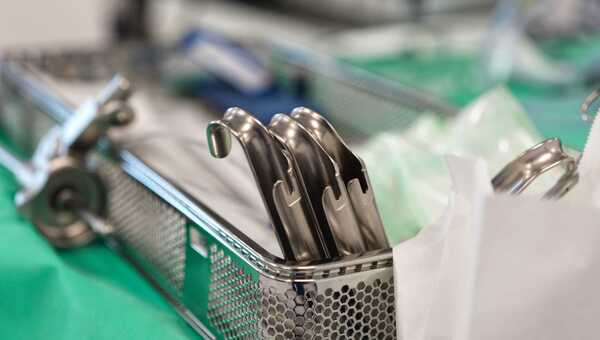 Photograph of a tray of metal medical devices prepared for a procedure